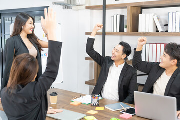 Happy Business People At Computer Celebrating Success At Work Sitting In Modern Office. Successful Negotiations. business team looking at the computer monitor.