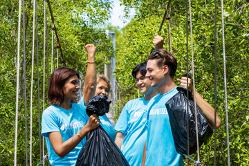 Team of young and diversity volunteer worker group enjoy charitable social work outdoor in cleaning up garbage project at mangrove forest - obrazy, fototapety, plakaty