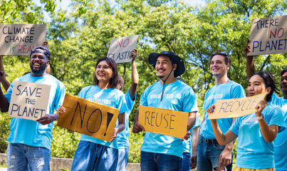 ..Diversity group of volunteer activist demonstrating in protest for global warming and climate change project with written placard for environmental awareness and reducing plastic consumption concept