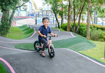 A Boy riding his bicycle on a pump track, Bike Park, Thailand