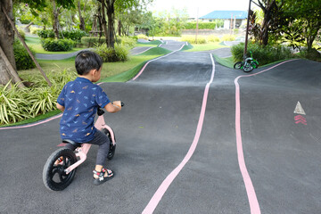 Obraz premium A Boy riding his bicycle on a pump track, Bike Park, Thailand