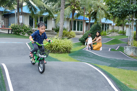 A Boy riding his bicycle on a pump track, Bike Park, Thailand