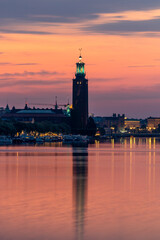 Fototapeta premium Stockholm, Sweden The City Hall or Stadshuset at dawn reflected in Riddarjarden.