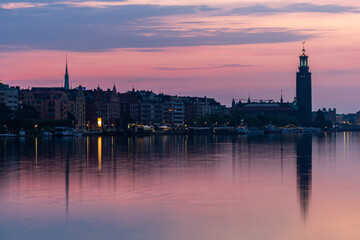 Fototapeta premium Stockholm, Sweden The City Hall or Stadshuset at dawn reflected in Riddarjarden.