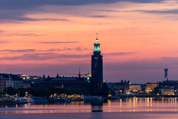 Fototapeta premium Stockholm, Sweden The City Hall or Stadshuset at dawn reflected in Riddarjarden.
