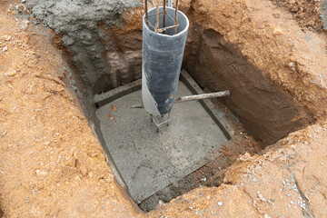 New preparing the foundation for construction columns with cement pole. Cement foundation with round cast columns with rebar for house pillars.