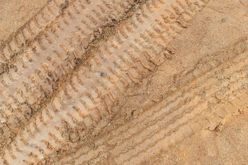 Above view  of liquid mud off road and there are marks of tires.
