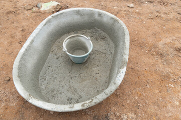 Plastic cement mixer on the soil. with plastic cement tank placed placed inside.