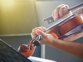 Close up hands of student on violin lesson in the room.   © Boon