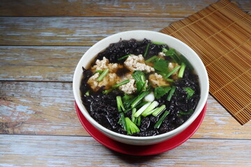 Traditional hot soup of fresh seaweed and minced pork serving in the bowl. Famous soft and light...