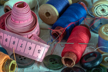 Sewing accessories. Spools of thread, needles and a soft centimeter. Vintage.
