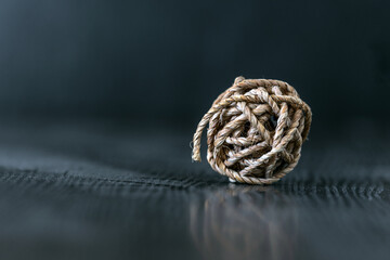 Ball woven from twine. Soft background.