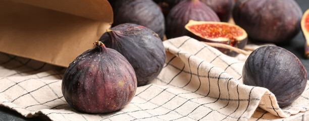 Bag with fresh figs on table, closeup
