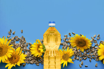 Composition with sunflower oil and seeds on blue background, top view