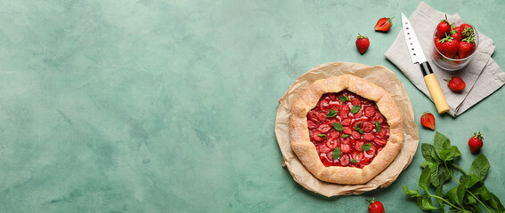 Delicious strawberry galette on green background with space for text