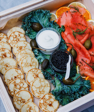 Appetizer platter of smoked salmon, Caviar, blinis, cr&egrave;me fra&icirc;che, and fruit