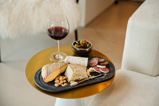 Red wine with gourmet cheeses, nuts, salami and olives