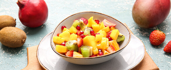 Bowl with sweet fruit salad on table