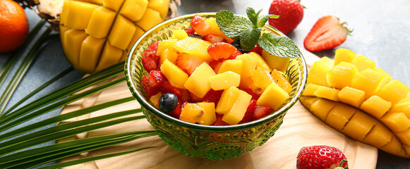 Bowl with sweet fruit salad on table
