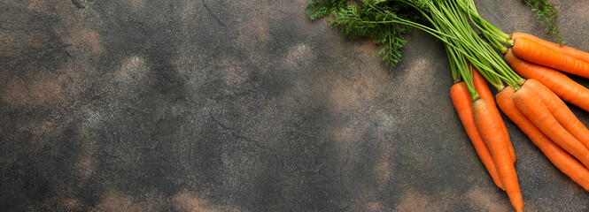 Fresh carrot on grunge background with space for text