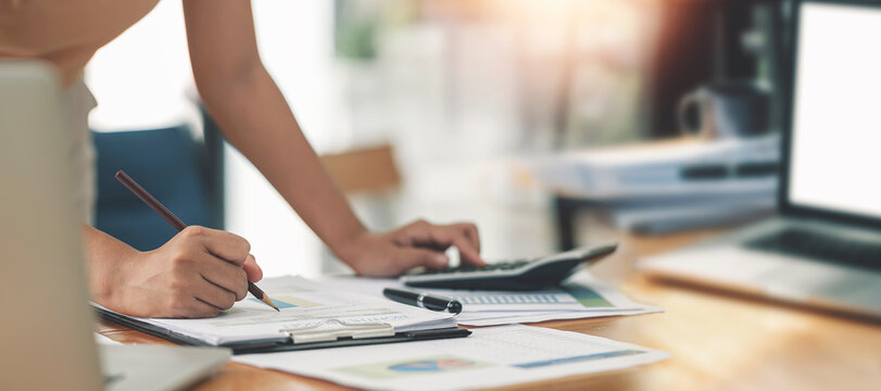 Businesswoman or accountant working Financial investment on calculator, calculate, analyze business and marketing growth on financial document