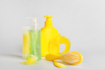 Bath accessories for baby and pacifier on light background
