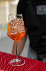 Spritz Cocktail in glasses with ice and orange slice on light  background.