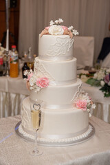 The bride's cake with white and pink roses at the wedding
