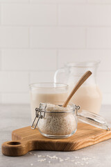 A jar of raw rice and rice milk in a glass on a plank. Healthy food concept, alternative milk.