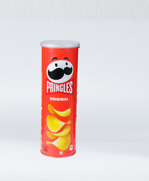 Zaporizhzhia, Ukraine - May 27, 2022: PRINGLES original potato chips in a package on a light paper background