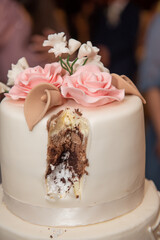 The bride's cake with white and pink roses at the wedding