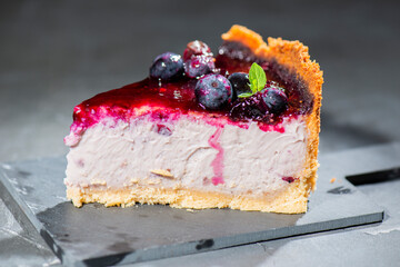 Homemade blueberry cheesecake with fresh blueberries, compote, and mint.