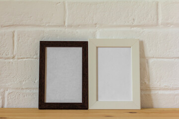 Fototapeta premium Empty photo frames on the table with copy space.