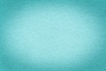 Texture of vintage light blue paper gradient background with dark vignette. Structure of dense craft cerulean cardboard