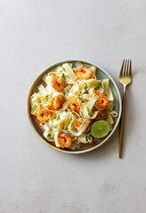 Pasta fettuccine in a creamy sauce with shrimp, lime and sage. Italian food.