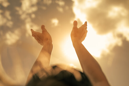 People happiness, hope, light , and power concept. Woman with arms raised to the colorful sky