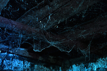 a creepy spider web hanging from the ceiling of an old abandoned house