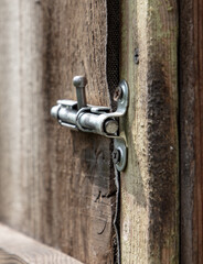 A latch on an old wooden door.