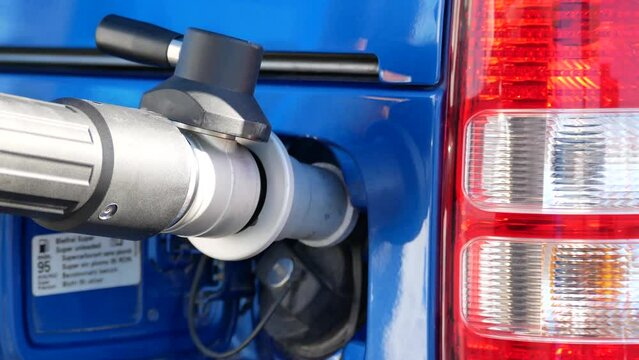 Compressed natural gas (CNG) vehicle fuel nozzle connected to car