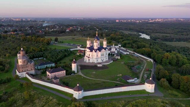 Forward reveal aerial shot of Svensky Uspensky Monastery on summer sunset. Suponevo, Bryansk Oblast, Russia.