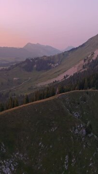 Vertical aerial footage of the Swiss alps slopes during sunset