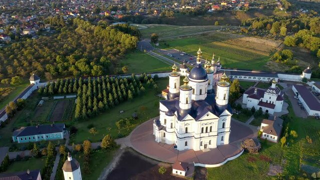 Orbital aerial shot of Svensky Uspensky Monastery on summer sunset. Suponevo, Bryansk Oblast, Russia.