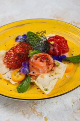 three types of fish in slices on pita bread in a yellow plate, vertical macro photo
