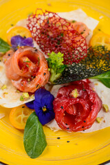 three types of fish in slices on pita bread in a yellow plate, macro photo
