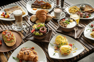many mixed western breakfast food items on cafe table