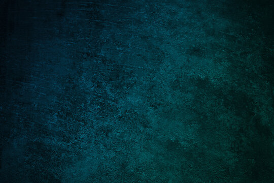 Dark blue green wall texture. Gradient. Deep teal color. Toned old rough concrete surface. Close-up. Abstract. Grunge background with space for design. Web banner.