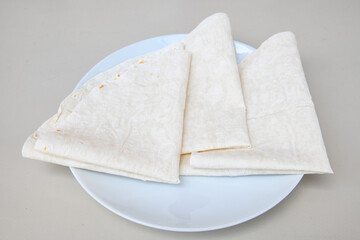 Bread, lavash ( Lavaş ) on white table.