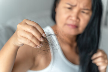 Asian woman with hair fall problem. Hair care and beauty concepts..