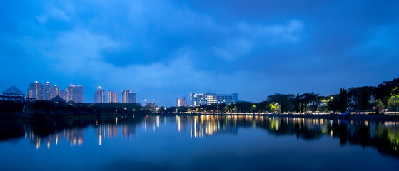 Blue hour city skyline with reflection of building in west Surabaya, Surabaya city, Indonesia. Wide angle photo