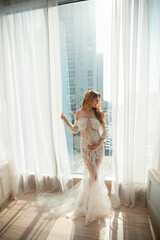 beautiful young pregnant woman in elegant dress	